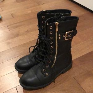 Black combat boots with gold details